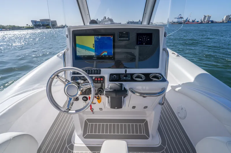 Slide: The Image of Cockpit of 2025 Airship 340 boat with steering wheel and navigation display on open water. - 31