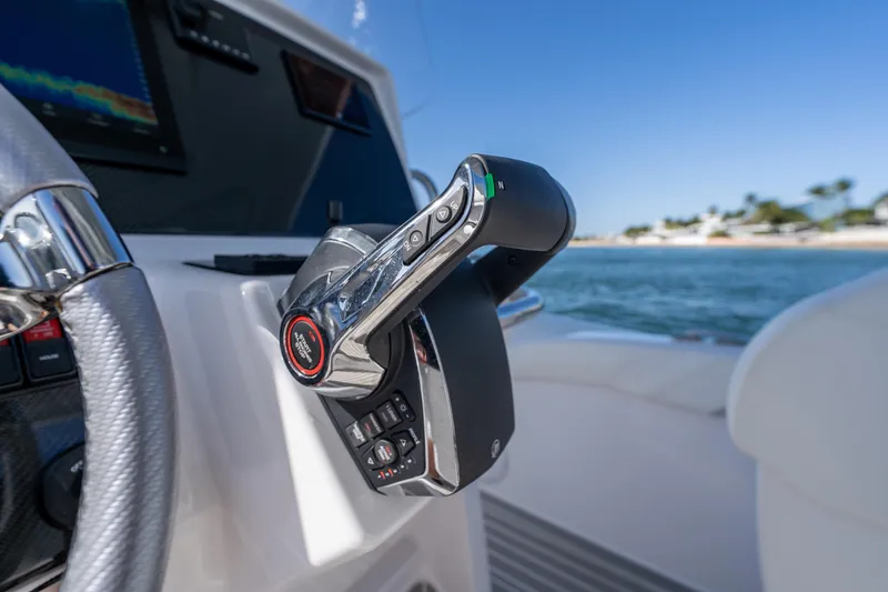 Slide: The Image of Close-up of Airship 340 boat controls, 2025 model, with ocean view in background. - 34