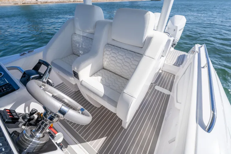 Slide: The Image of Luxurious Airship 340 boat interior with white leather seats, 2025 model, on open water. - 36