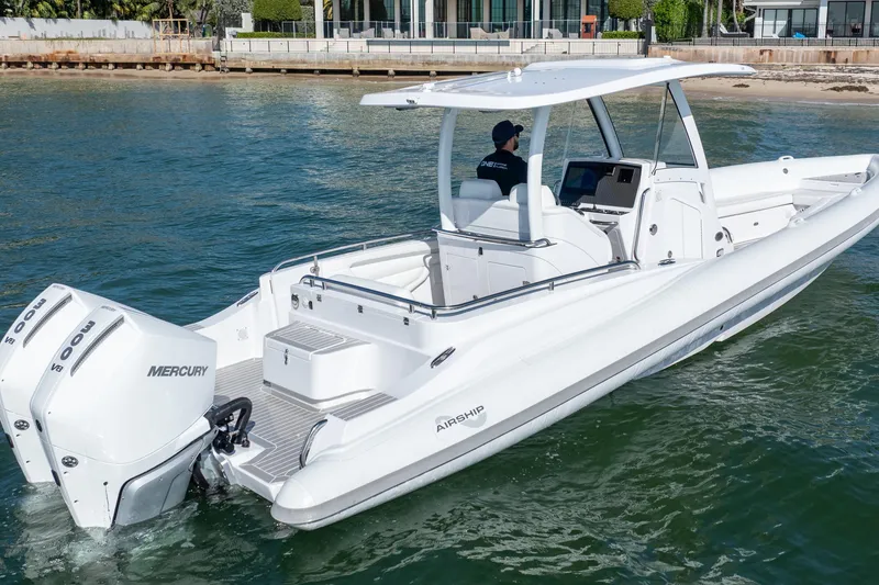 Slide: The Image of 2025 Airship 340 boat with dual Mercury engines cruising on water. - 4