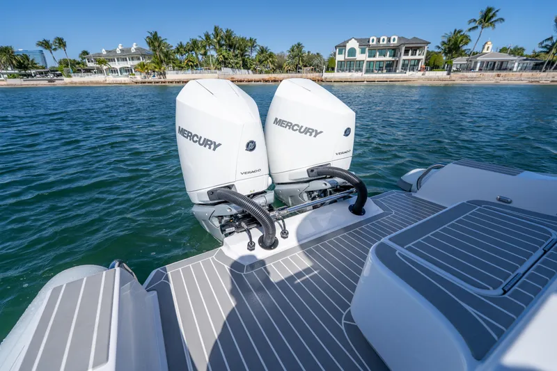 Slide: The Image of Twin Mercury Verado engines on Airship 340 boat, 2025 model, near waterfront homes. - 40