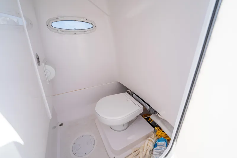 Slide: The Image of Compact bathroom in 2025 Airship 340 model, featuring a toilet and porthole window. - 42