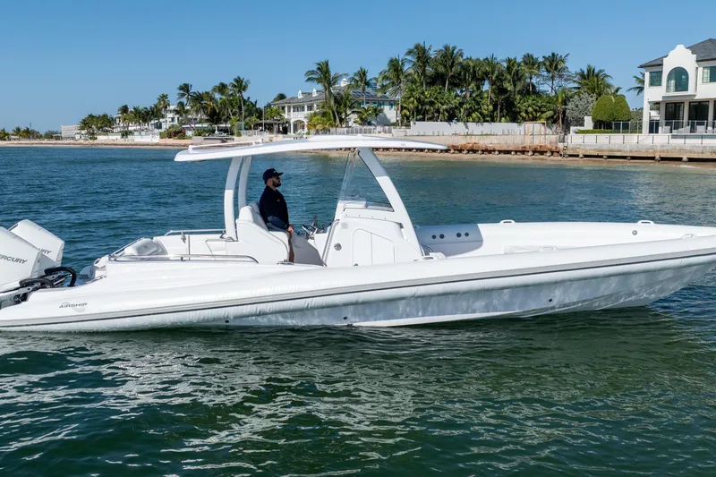 Slide: The Image of 2025 Airship 340 boat cruising near a coastal residential area. - 5