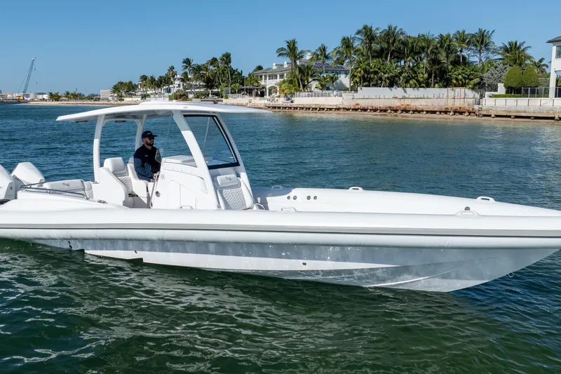 Slide: The Image of 2025 Airship 340 boat cruising on a sunny day near a tropical shoreline. - 6
