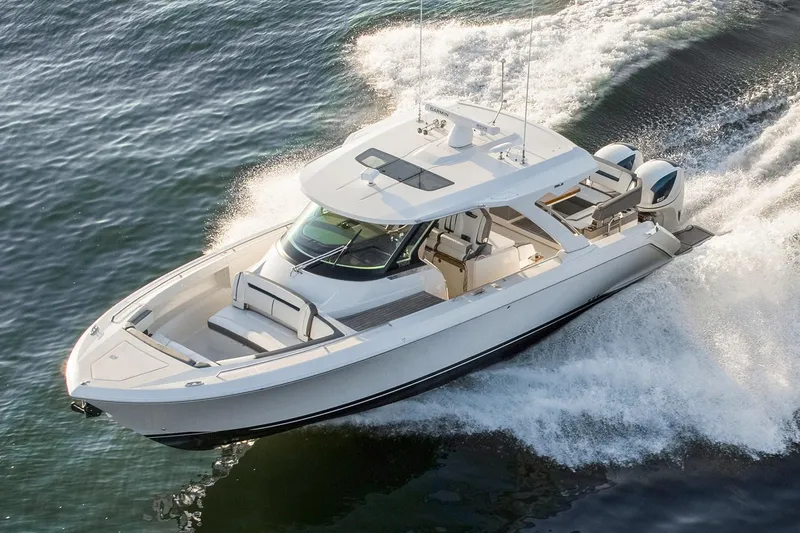 Slide: The Image of 2021 Tiara Sport 38 LX boat cruising on water, featuring sleek design and modern amenities. - 1