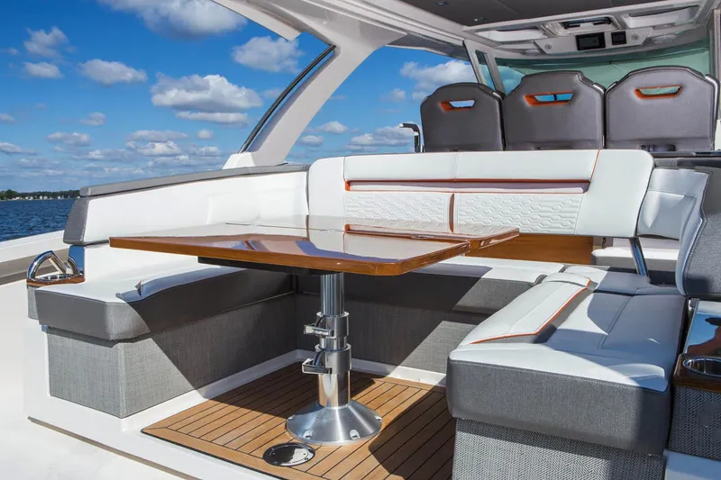 Slide: The Image of 2021 Tiara Sport 38 LX boat on water, aerial view, showcasing sleek design. - 12