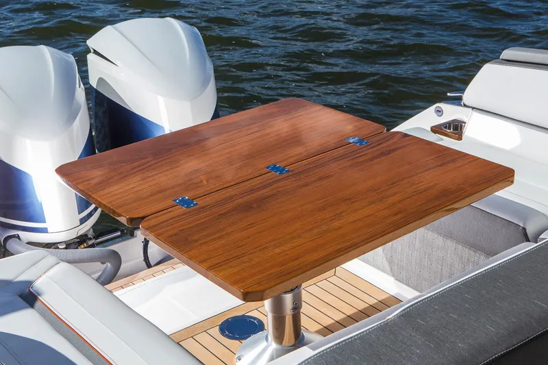 Slide: The Image of 2021 Tiara Sport 38 LX boat interior with white seating and waterfront view. - 14