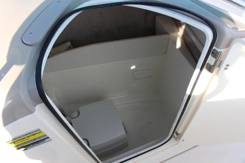 Slide: The Image of 2004 Maxum 2400 SR boat interior storage compartment with open door. - 12