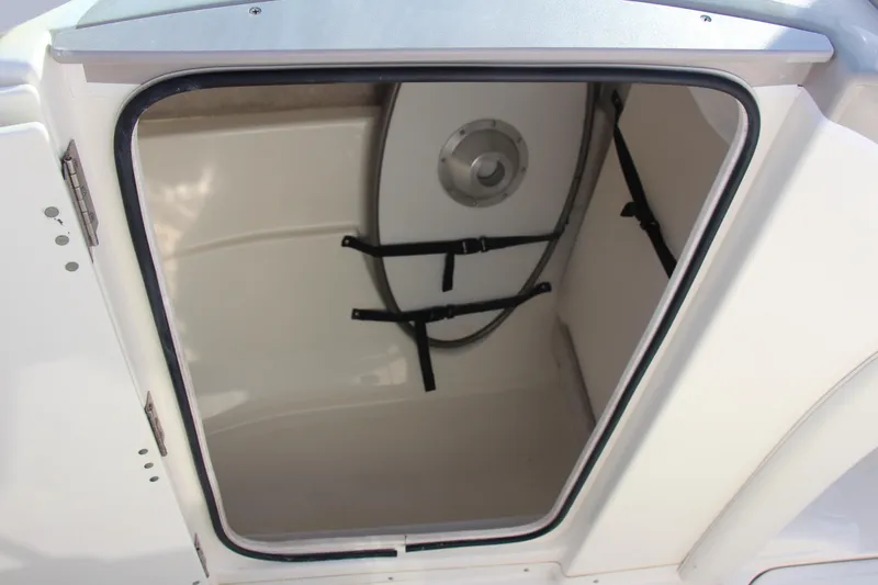 Slide: The Image of 2004 Maxum 2400 SR boat storage compartment with open hatch and interior view. - 13