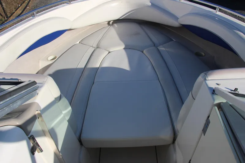 Slide: The Image of 2004 Maxum 2400 SR boat interior with cushioned seating and sleek design. - 16