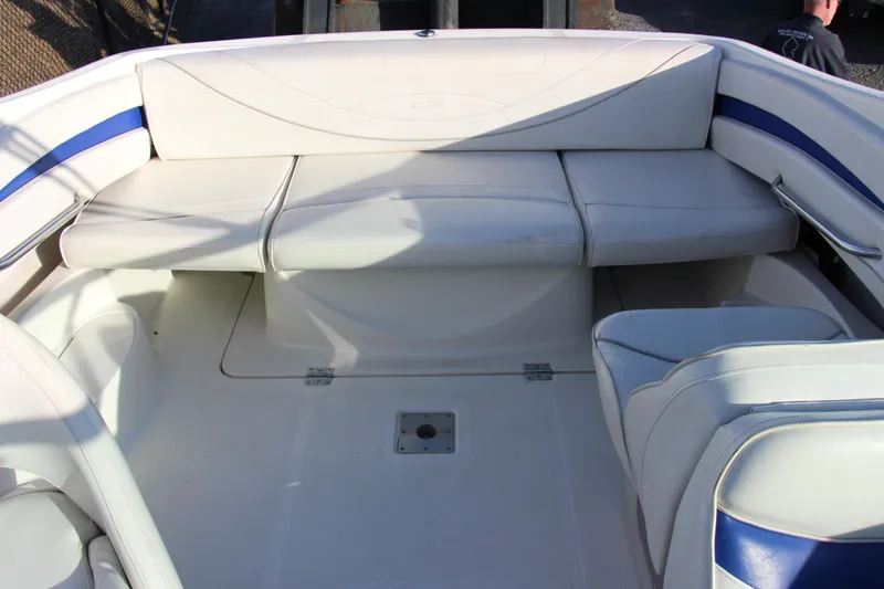 Slide: The Image of 2004 Maxum 2400 SR boat interior with white and blue seating arrangement. - 20