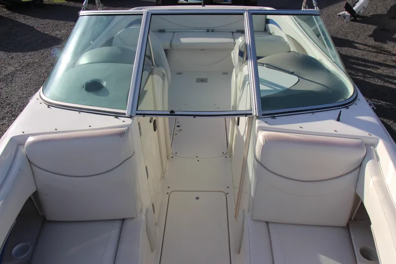 Slide: The Image of 2004 Maxum 2400 SR boat interior with white seating and windshield. - 8