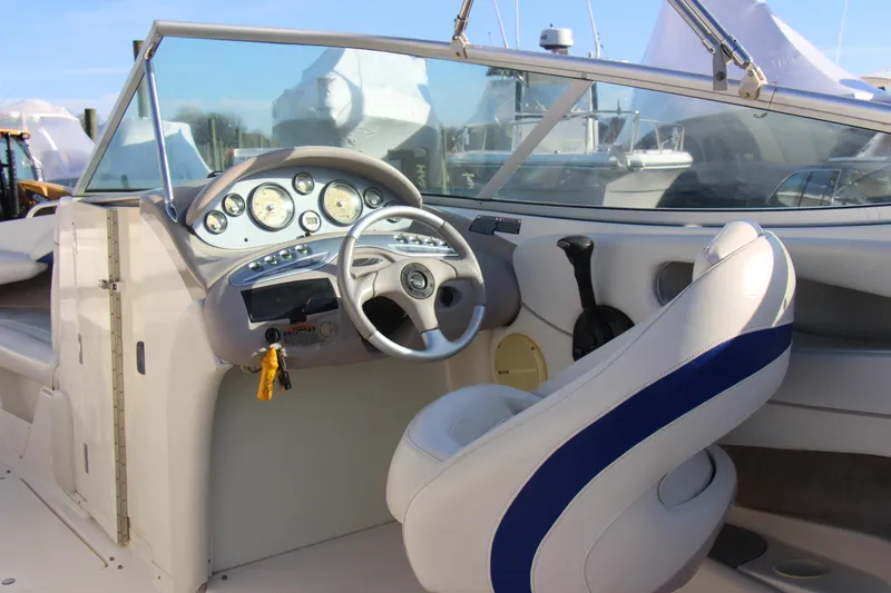 Slide: The Image of 2004 Maxum 2400 SR boat interior with steering wheel and dashboard controls. - 9