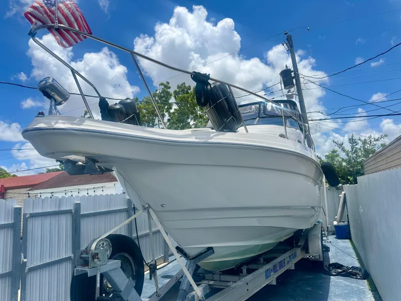 Slide: The Image of 2001 Regal Commodore 2760 boat on trailer, parked outdoors under a blue sky. - 1