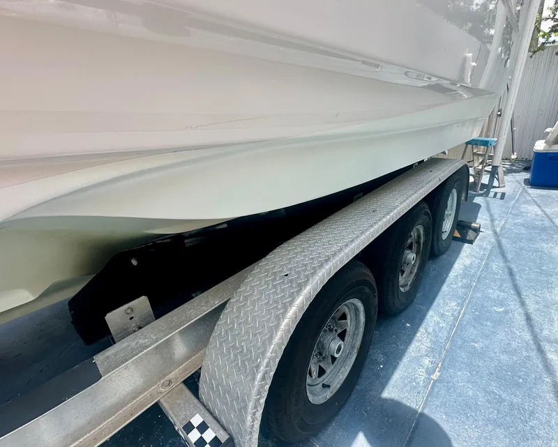 Slide: The Image of 2001 Regal Commodore 2760 boat on a triple-axle trailer, side view. - 13