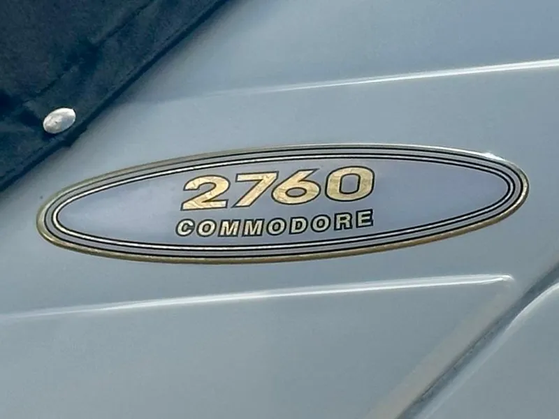 Slide: The Image of 2001 Regal Commodore 2760 boat emblem on a sleek surface. - 14