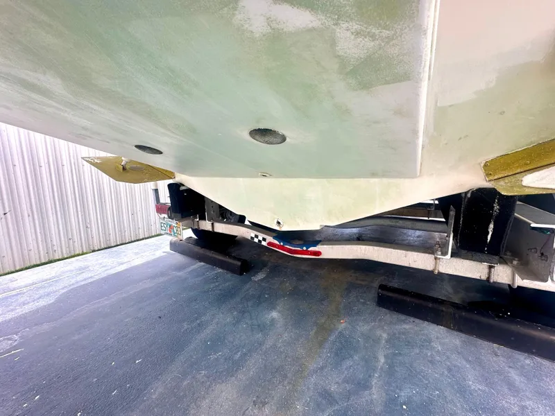 Slide: The Image of 2001 Regal Commodore 2760 boat underside on trailer, showing hull and propeller details. - 15