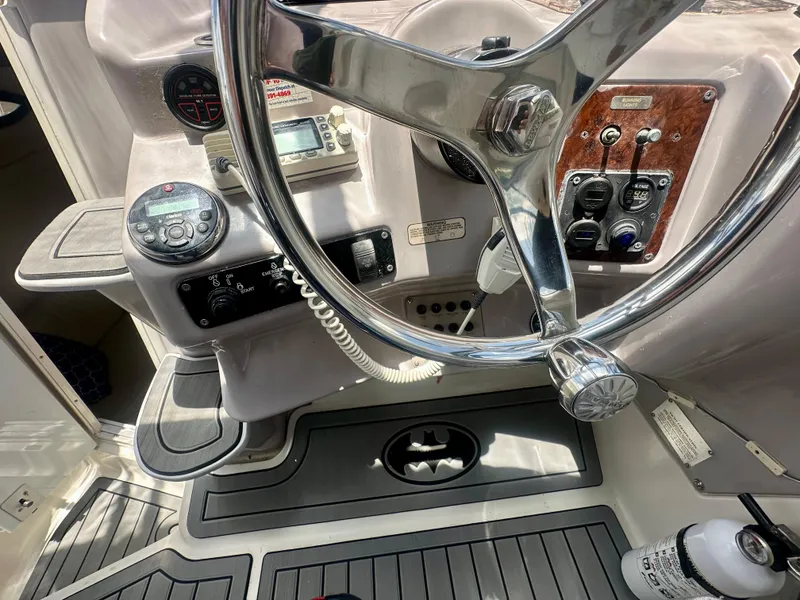 Slide: The Image of 2001 Regal Commodore 2760 boat helm with steering wheel and control panel. - 19
