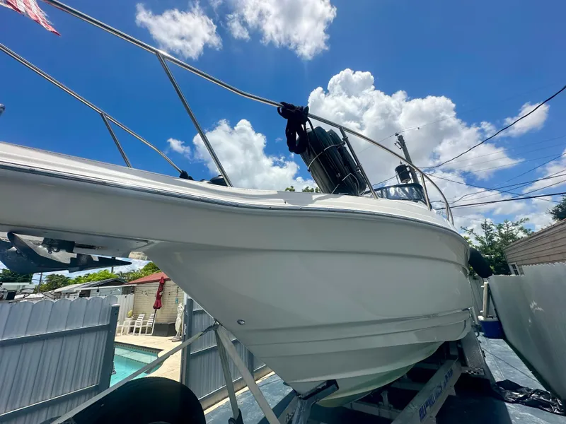 Slide: The Image of 2001 Regal Commodore 2760 boat on trailer under blue sky with clouds. - 2