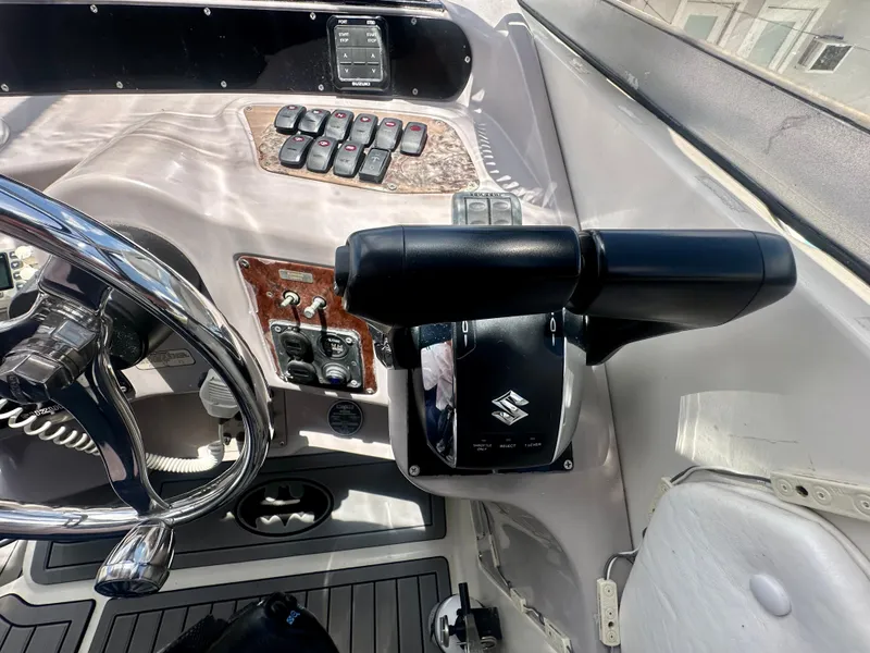 Slide: The Image of 2001 Regal Commodore 2760 boat dashboard with steering wheel and control panel. - 20