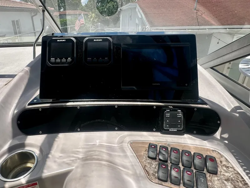Slide: The Image of 2001 Regal Commodore 2760 dashboard with Suzuki controls and Garmin display. - 21