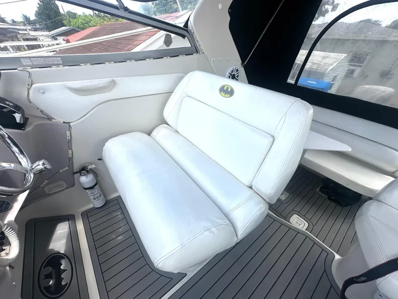 Slide: The Image of 2001 Regal Commodore 2760 boat interior with white seating and Batman logo. - 23