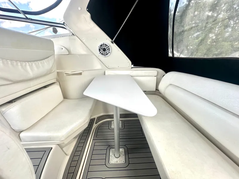 Slide: The Image of Interior of 2001 Regal Commodore 2760 boat with white seating and table. - 26