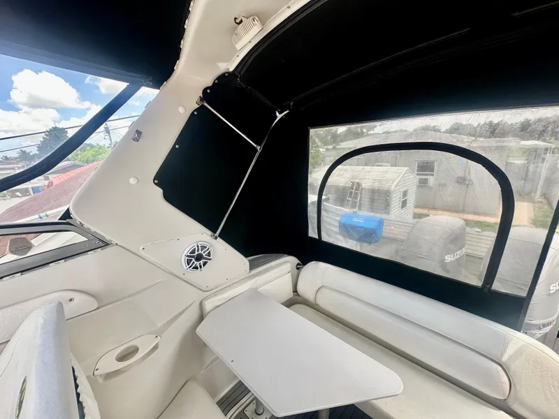 Slide: The Image of 2001 Regal Commodore 2760 boat interior with seating, table, and speaker. - 29