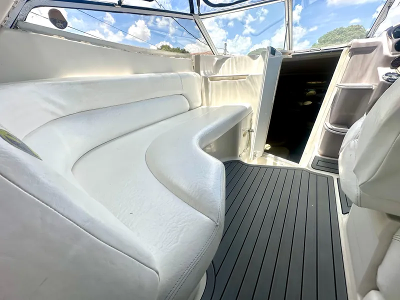 Slide: The Image of 2001 Regal Commodore 2760 boat interior with white seating and open cabin door. - 31
