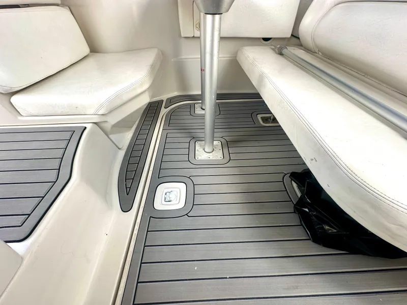 Slide: The Image of 2001 Regal Commodore 2760 boat interior with cushioned seating and sleek flooring. - 32