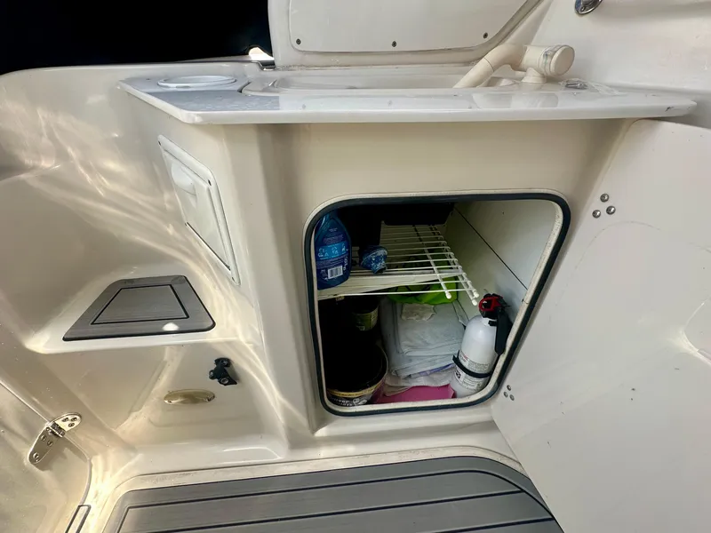 Slide: The Image of 2001 Regal Commodore 2760 boat interior storage with shelves and fire extinguisher. - 35