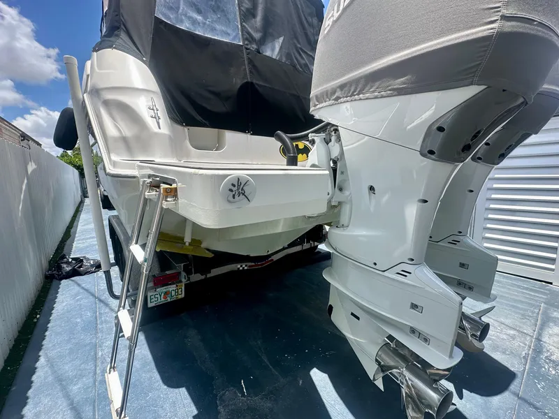 Slide: The Image of 2001 Regal Commodore 2760 boat with dual outboard motors and ladder, parked on a trailer. - 40