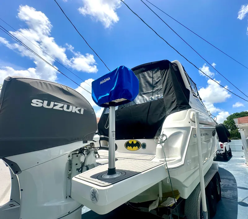 Slide: The Image of 2001 Regal Commodore 2760 boat with Suzuki engine, blue Magma cover, and Batman logo. - 41