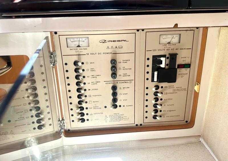 Slide: The Image of Control panel of a 2001 Regal Commodore 2760 boat, showing electrical switches and gauges. - 43