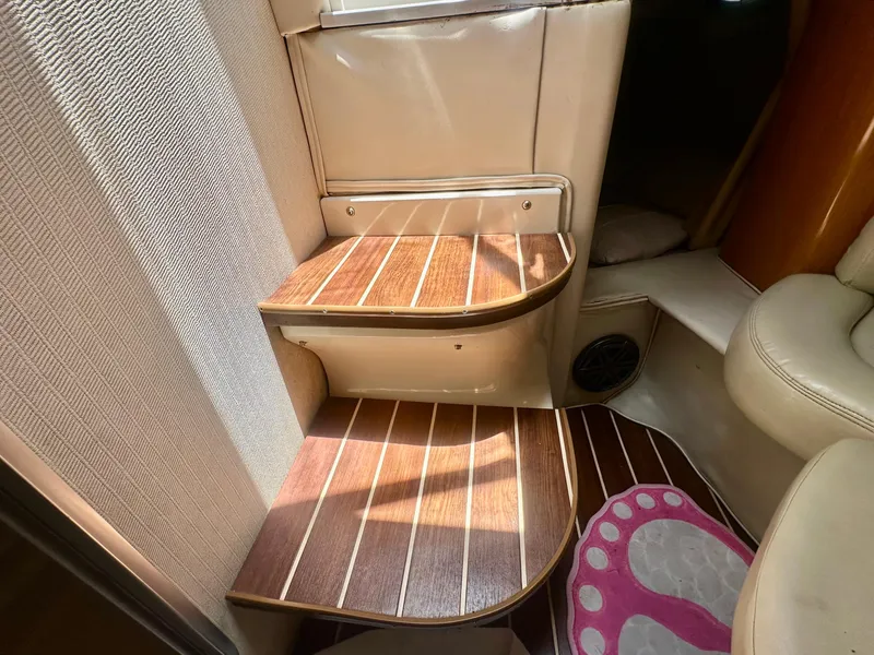 Slide: The Image of Interior steps of a 2001 Regal Commodore 2760 boat with wood finish. - 46