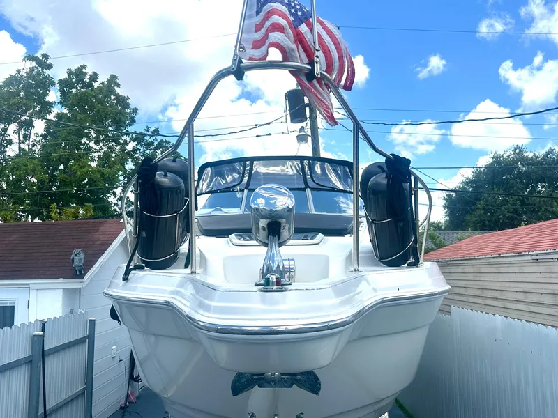 Slide: The Image of 2001 Regal Commodore 2760 boat with American flag, docked in residential area. - 8