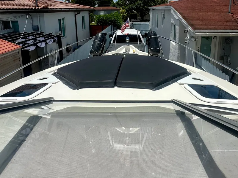 Slide: The Image of 2001 Regal Commodore 2760 boat docked between houses, featuring sleek design and American flag. - 9