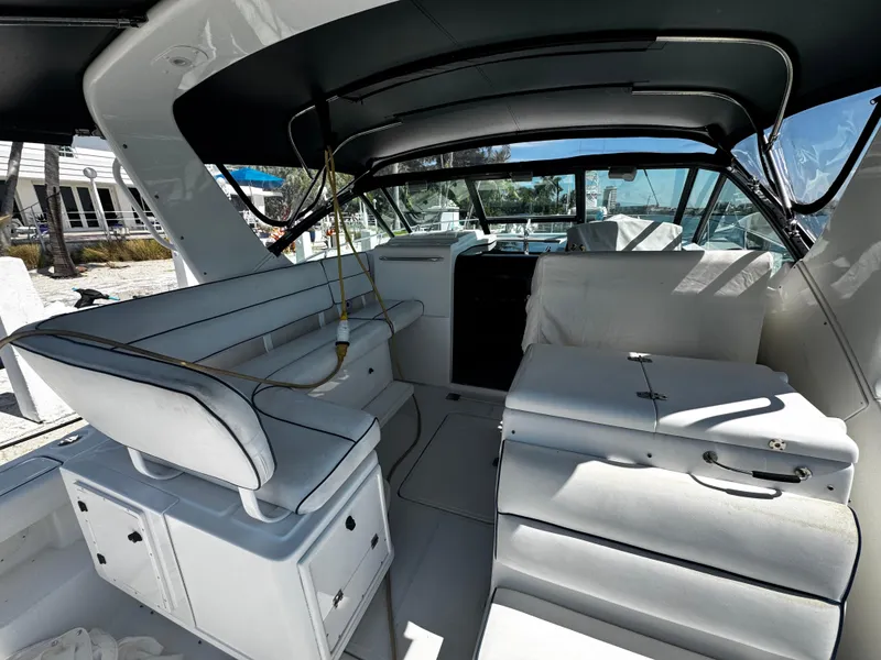 Slide: The Image of Interior of 2000 Tiara Yachts 3500 Open, featuring sleek white seating and modern design. - 14