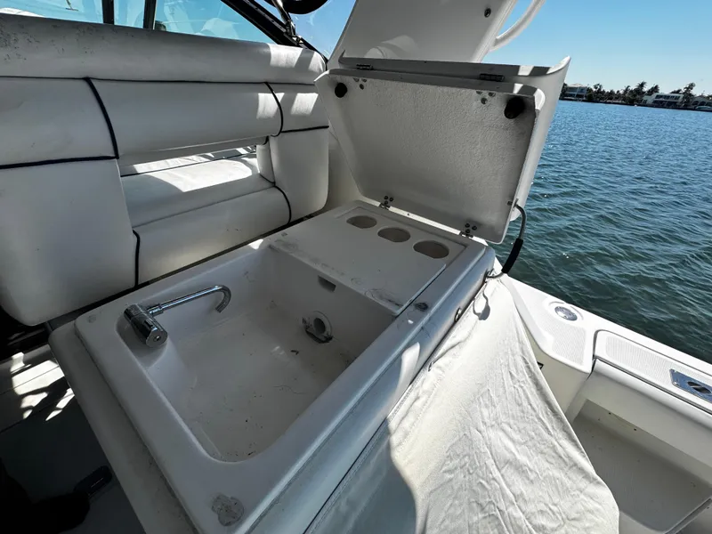 Slide: The Image of Open storage compartment on 2000 Tiara Yachts 3500 Open, near water. - 17
