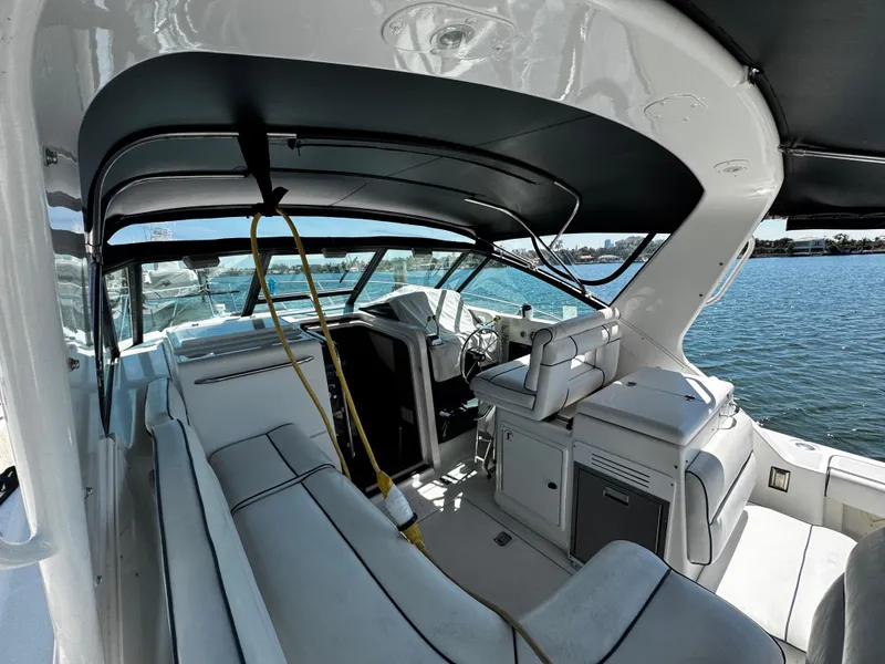 Slide: The Image of 2000 Tiara Yachts 3500 Open interior with seating and helm, docked by the water. - 21