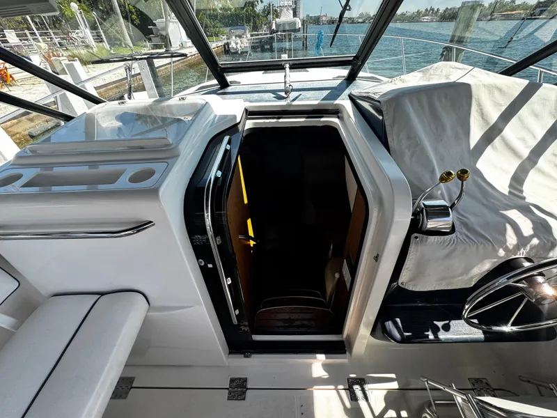 Slide: The Image of 2000 Tiara Yachts 3500 Open interior view with helm and cabin entrance. - 27