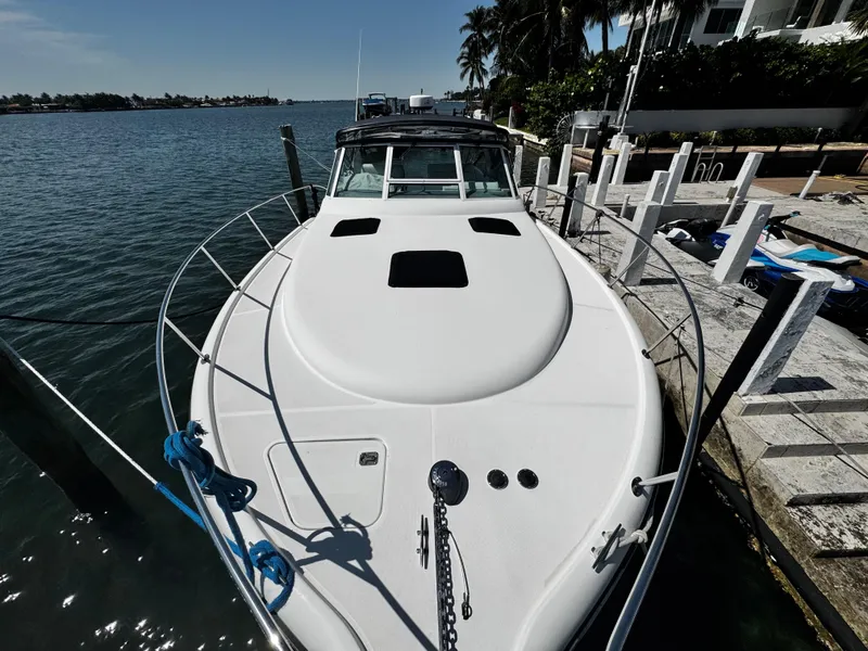 Slide: The Image of 2000 Tiara Yachts 3500 Open docked by the waterfront, showcasing sleek design and spacious deck. - 29