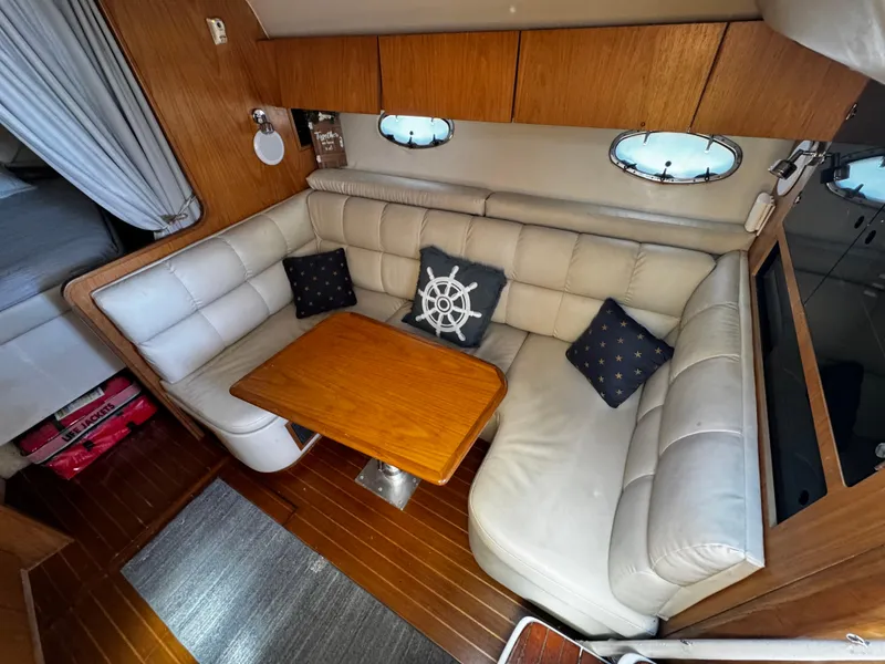 Slide: The Image of 2000 Tiara Yachts 3500 Open interior with cozy seating and wooden table. - 32