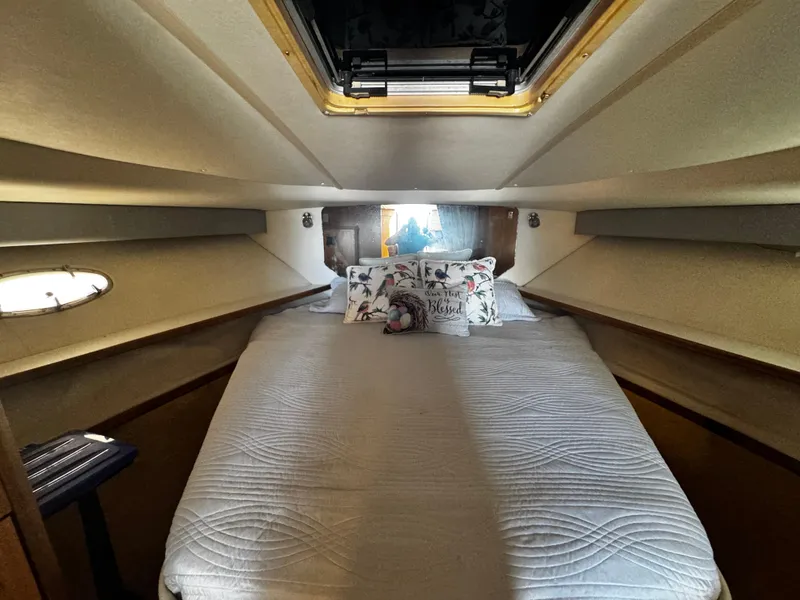 Slide: The Image of Cozy cabin interior of 2000 Tiara Yachts 3500 Open with bed and decorative pillows. - 39