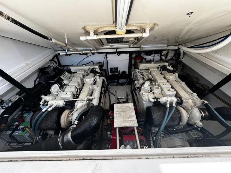 Slide: The Image of Engine room of a 2000 Tiara Yachts 3500 Open, featuring dual engines and mechanical components. - 42