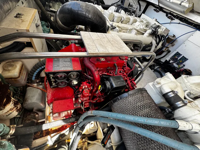 Slide: The Image of Engine compartment of a 2000 Tiara Yachts 3500 Open, featuring a red engine. - 43