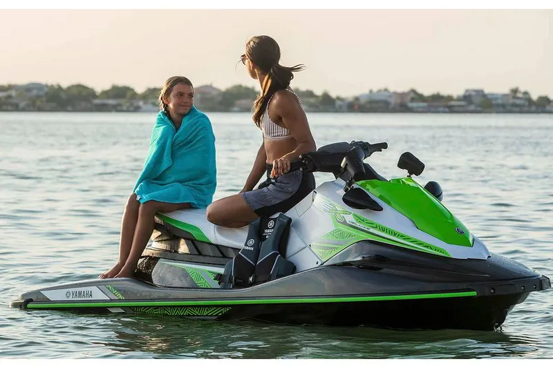 Slide: The Image of 2020 Yamaha WaveRunner EX Deluxe jet ski with blue and gray design in storage. - 3