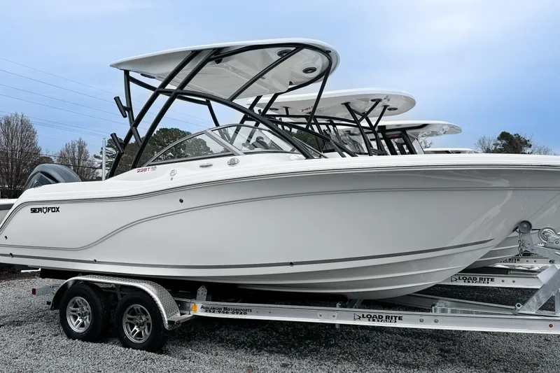 The Image of 2026 Sea Fox 228 Traveler boat on trailer, sleek design, white exterior, dual axles. - 0