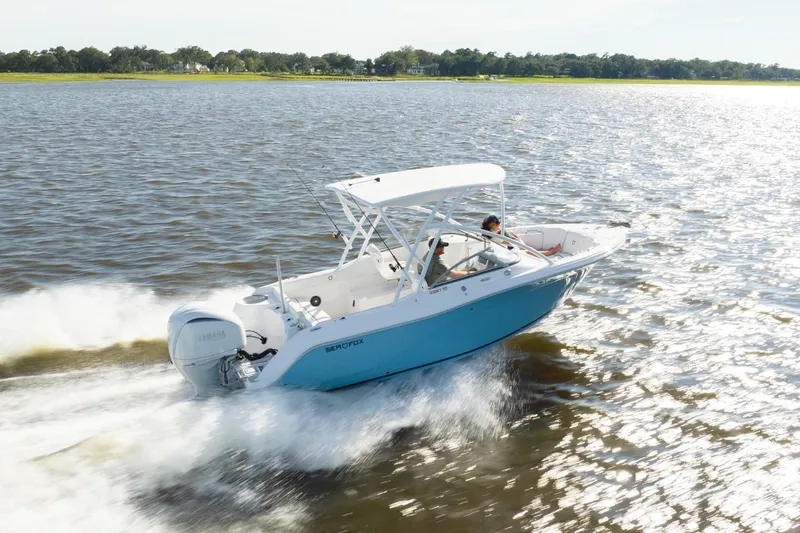Slide: The Image of 2026 Sea Fox 228 Traveler boat with powerful outboard motor, displayed in a marina. - 1