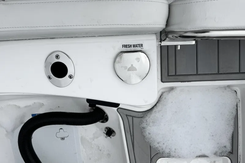 Slide: The Image of 2026 Sea Fox 228 Traveler boat storage compartment with open door and capacity label. - 6